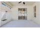 Covered patio features ceiling fan, sliding glass door and window to outdoors at 8329 Moccasin Trail Dr, Riverview, FL 33578