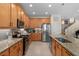 Well-lit kitchen with stainless steel appliances, granite counters, and center island with a stainless steel sink at 8961 Garden Party Dr, Land O Lakes, FL 34637