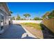 A fenced backyard featuring a cement patio and a combination of grass and sand at 101 Sunlit Cove Ne Dr, St Petersburg, FL 33702