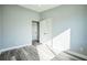 Spacious bedroom with light gray walls, featuring modern flooring, closet space, and a clean, minimalist design at 101 Sunlit Cove Ne Dr, St Petersburg, FL 33702