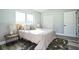 Charming bedroom with wood-look floors, closet, natural light, and a cozy rug at 101 Sunlit Cove Ne Dr, St Petersburg, FL 33702