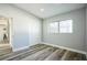 Bright bedroom with wood-look floors, ample natural light, and closet for convenient storage at 101 Sunlit Cove Ne Dr, St Petersburg, FL 33702