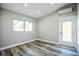 Inviting bedroom featuring wood-look floors, recessed lighting, a window and an exterior door at 101 Sunlit Cove Ne Dr, St Petersburg, FL 33702