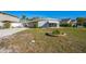 Exterior shot of a home with a stone-ringed garden bed and rock driveway at 101 Sunlit Cove Ne Dr, St Petersburg, FL 33702