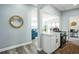 Bright kitchen featuring white cabinets and quartz countertops, open to the living area at 101 Sunlit Cove Ne Dr, St Petersburg, FL 33702