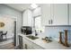 Well-appointed kitchen featuring sleek white cabinetry, modern appliances and quartz counters at 101 Sunlit Cove Ne Dr, St Petersburg, FL 33702