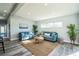 Bright living room with wood-look floors, comfortable seating, and ample natural light at 101 Sunlit Cove Ne Dr, St Petersburg, FL 33702
