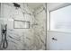 Modern shower featuring beautiful marble-look tile, and sleek fixtures at 101 Sunlit Cove Ne Dr, St Petersburg, FL 33702