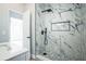 Modern shower featuring beautiful marble-look tile, and sleek black fixtures at 101 Sunlit Cove Ne Dr, St Petersburg, FL 33702
