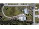 Aerial view of home with a circular driveway and lush grounds at 1019 Canal St, Ruskin, FL 33570