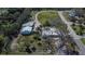 An aerial view showcases the property's expansive lot, surrounding greenery, and proximity to the neighborhood at 1019 Canal St, Ruskin, FL 33570