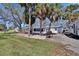 Spacious backyard with palm trees, a fenced-in area, a fire pit, and a grill at 1019 Canal St, Ruskin, FL 33570