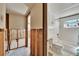 Bathroom and hallway that shows damage to the walls, flooring, and the need for renovations at 1019 Canal St, Ruskin, FL 33570