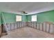 Image of bedroom with green walls that is undergoing renovations and in need of repairs at 1019 Canal St, Ruskin, FL 33570