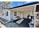 Back view of house showing the carport with table and storage at 1019 Canal St, Ruskin, FL 33570