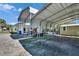 Outdoor carport with metal roof and posts next to a shed, providing covered parking and storage space at 1019 Canal St, Ruskin, FL 33570