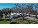 Charming single-story home with a metal roof, mature trees, and landscaping at 1019 Canal St, Ruskin, FL 33570
