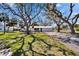 Charming single-story home featuring a mature landscaped yard with beautiful trees and a private driveway at 1019 Canal St, Ruskin, FL 33570