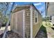 Exterior shot of a shed featuring a large metal door and window, and a moss-covered exterior at 1019 Canal St, Ruskin, FL 33570