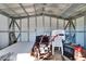 Interior view of the storage shed featuring metal framework, chairs, and a small motor at 1019 Canal St, Ruskin, FL 33570