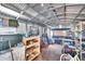 Interior view of a storage shed featuring a bicycle, shelving, a ladder, and various household items at 1019 Canal St, Ruskin, FL 33570