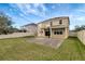A spacious backyard includes a covered patio with a basketball hoop and fenced perimeter at 10909 Observatory Way, Tampa, FL 33647