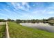 Scenic view of the lake from the backyard, showcasing the serene and tranquil waterfront property at 10909 Observatory Way, Tampa, FL 33647