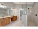 Bright bathroom features a soaking tub, a glass-enclosed shower, and a double vanity at 10909 Observatory Way, Tampa, FL 33647