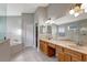 Bright bathroom features a soaking tub, double vanity, and a large mirror at 10909 Observatory Way, Tampa, FL 33647