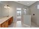 Bright bathroom features a soaking tub, a glass-enclosed shower, and a double vanity at 10909 Observatory Way, Tampa, FL 33647