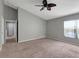 Expansive primary bedroom with carpet, ceiling fan, and lots of natural light at 10909 Observatory Way, Tampa, FL 33647