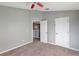 Bedroom featuring neutral walls, carpet floors, ceiling fan and white doors at 10909 Observatory Way, Tampa, FL 33647