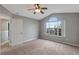 Bedroom featuring neutral walls, carpet floors, and a window overlooking trees at 10909 Observatory Way, Tampa, FL 33647