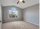 Bedroom featuring neutral walls, carpet floors, and a window overlooking trees at 10909 Observatory Way, Tampa, FL 33647