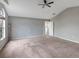 Spacious carpeted bedroom featuring a ceiling fan and neutral walls, offering a serene atmosphere at 10909 Observatory Way, Tampa, FL 33647