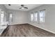This bedroom features hardwood floors, light grey walls, and large windows at 10909 Observatory Way, Tampa, FL 33647