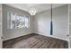 Bedroom features stylish wood floors, a modern light, and large window at 10909 Observatory Way, Tampa, FL 33647