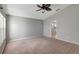 Spacious bedroom features a ceiling fan and plush carpet at 10909 Observatory Way, Tampa, FL 33647