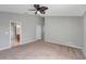 Large bedroom with ceiling fan and carpet at 10909 Observatory Way, Tampa, FL 33647