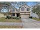 Charming two-story house with a two-car garage and manicured landscaping at 10909 Observatory Way, Tampa, FL 33647