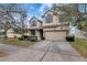 Inviting curb appeal with a well-kept lawn and an attached two-car garage at 10909 Observatory Way, Tampa, FL 33647