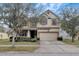 Two-story home features a well-maintained lawn and a beige stucco facade at 10909 Observatory Way, Tampa, FL 33647