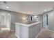 Hallway with carpet flooring, a pendant light fixture, and white railings at 10909 Observatory Way, Tampa, FL 33647