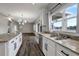 Spacious kitchen with island, white cabinets, granite countertops, stainless steel appliances, and wood floors at 10909 Observatory Way, Tampa, FL 33647