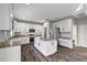 This kitchen features white cabinets, stainless steel appliances, hardwood floors, and a granite topped island at 10909 Observatory Way, Tampa, FL 33647