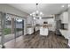 This kitchen features white cabinets, stainless steel appliances, and hardwood floors at 10909 Observatory Way, Tampa, FL 33647