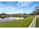 Picturesque view of the lake from the backyard, showcasing the peaceful and scenic waterfront property at 10909 Observatory Way, Tampa, FL 33647