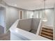 Bright landing with neutral walls, staircase and contemporary lighting, creating an inviting transition space at 10909 Observatory Way, Tampa, FL 33647