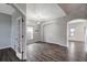 Open living space with wood floors, an archway, and a French door at 10909 Observatory Way, Tampa, FL 33647