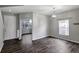 Bright living room with hardwood floors, a chandelier, and a large window at 10909 Observatory Way, Tampa, FL 33647